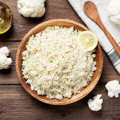 Homemade organic  cauliflower rice with spice in a wooden bowl.