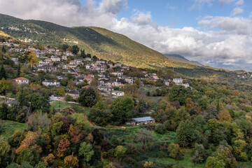 Obraz premium Panorama view of village Aristi with Picuresque stone buildings during fall season in Zagori Greece.