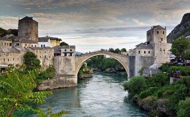 Fototapeta na wymiar View on Mostar city with old bridge (Stari Most) over the Neretva river and other white stone buildings in Bosnia and Herzegovina.