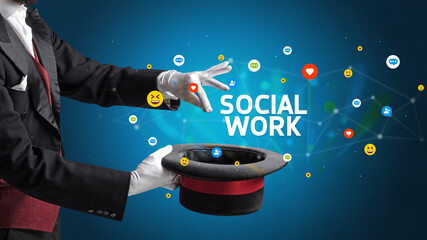 Magician is showing magic trick with SOCIAL WORK inscription, social media marketing concept