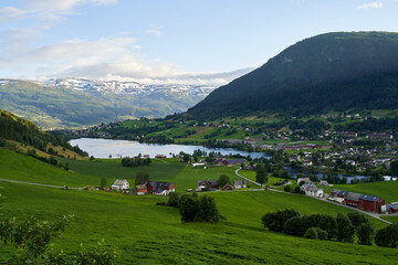 A sunny summer day in the Voss valley with green agricultural fields and farmhouses © Barnabas
