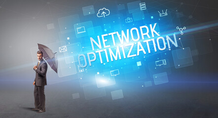 Businessman defending with umbrella from cyber attack and NETWORK OPTIMIZATION inscription, online security concept