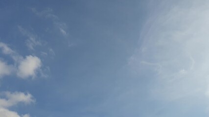 white clouds disappear in the hot sun on blue sky. Time-lapse motion clouds, blue sky background and sun
