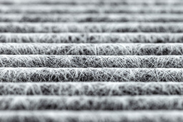 A macro shot of the surface rectangular, carbon cabin filter. Can be used as background, visible fibers arranged in horizontal lines.