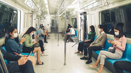 Crowd of people wearing face mask on a crowded public subway train travel . Coronavirus disease or...