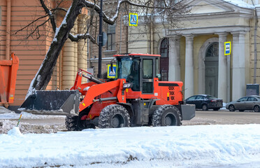 Snow removal in the city with special equipment and people.