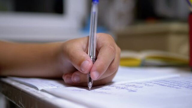Schoolboy Writes with Left Hand in Notebook, Using Handle. Online Home Training