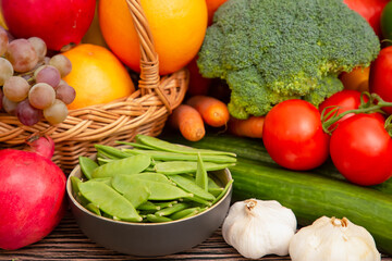 Group vegetables and Fruits Apples, grapes, oranges, and bananas in the wooden basket with carrots,...