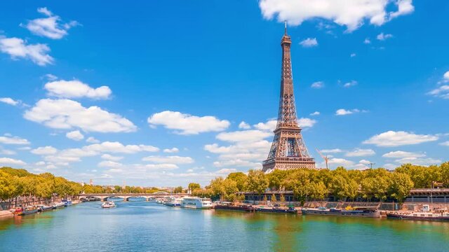 A timelapse of the Eiffel Tower along the river Seine with flyboats passing by with motion blur.Sunny but cloudy autumn day with golden yellow leaves,paris city riverside bay view bridge panorama