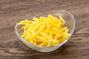 Shredded yellow cheese in the bowl