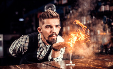 Bartender creates a cocktail in the alehouse