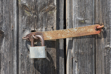 Background from an old wooden door with a rusty lock.