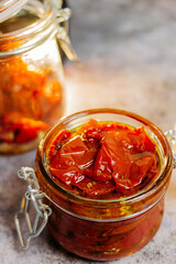 Fototapeta na wymiar sun-dried tomatoes with olive oil in a jar