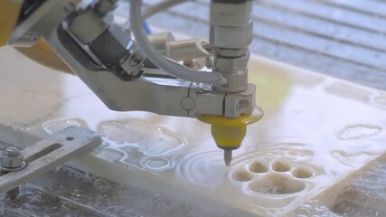 Industrial, manufacturing, technology concept. Fast extreme cnc automatic waterjet cutting machine working with stone by high-pressure water jet and abrasive substance - close up