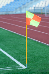 Corner flag on a green soccer field. Place of corner kick on a soccer field.