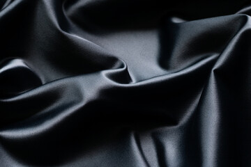 Black silk luxury abstract texture and background with folds.
