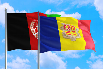 Andorra and Afghanistan national flag waving in the wind on a deep blue sky together. High quality fabric. International relations concept.