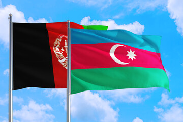 Azerbaijan and Afghanistan national flag waving in the wind on a deep blue sky together. High quality fabric. International relations concept.