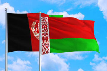 Belarus and Afghanistan national flag waving in the wind on a deep blue sky together. High quality fabric. International relations concept.