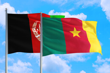 Cameroon and Afghanistan national flag waving in the wind on a deep blue sky together. High quality fabric. International relations concept.