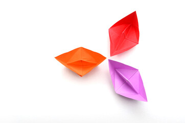 three colorful origami paper boats