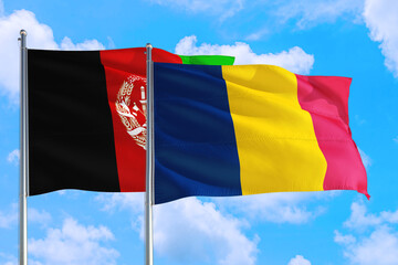 Chad and Afghanistan national flag waving in the wind on a deep blue sky together. High quality fabric. International relations concept.