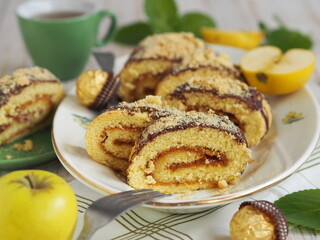 Closeup of pastry roll stuffed with apple jam on a wooden background. Home cooking.