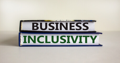 Books with text 'business inclusivity' on beautiful white background. Business and inclusivity concept. Copy space.