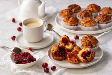 Homemade muffins with cranberry filling, on light background.