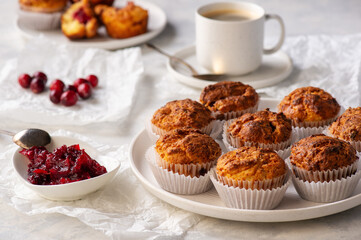 Homemade muffins with cranberry filling, on light background.