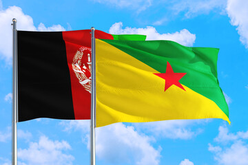 French Guiana and Afghanistan national flag waving in the wind on a deep blue sky together. High quality fabric. International relations concept.
