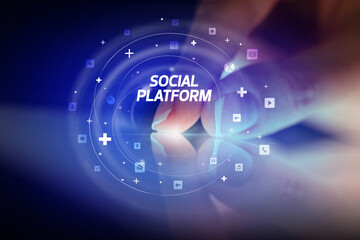 Finger touching tablet with social media icons and SOCIAL PLATFORM