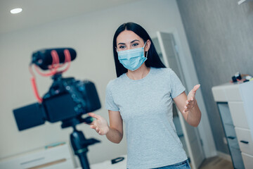 Fototapeta na wymiar Woman recording useful video about pandemic rules and measurements