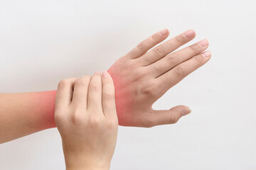 pain in wrist. close-up of female hand with red dot on white background