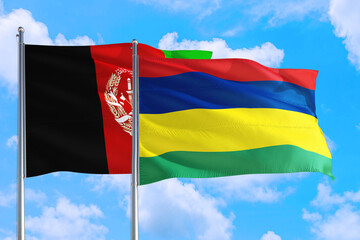 Mauritius and Afghanistan national flag waving in the wind on a deep blue sky together. High quality fabric. International relations concept.
