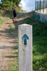 Hike Arrow Sign with Woman and Dog, Loredo; Santander