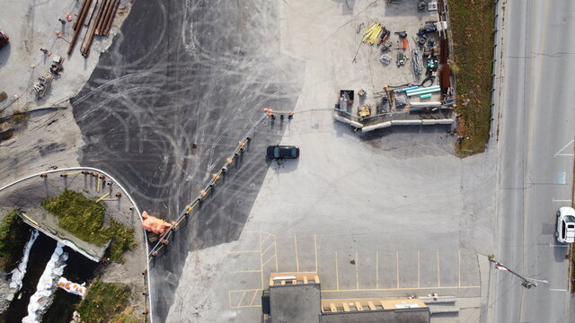 Aerial Image of a Construction Site in a Parking Lot with Construction Materials and Equipment