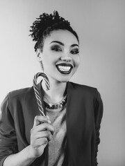 cheerful and happy afro american woman with candy cane. Christmas, new year, sugar, happiness, holidays concept