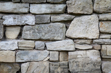 Eine Felswand, eine Wand aus vielen Bruchsteinen als Textur.