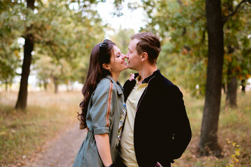 young couple flirting and hugging each other, outdoor candid lifestyle portrait