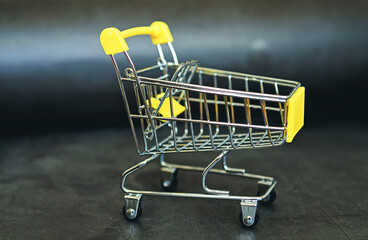 Food cart on a dark background. Creative idea for a sale, promotion, or concept for cyber Monday or black Friday.