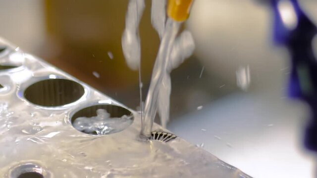 Automatic cnc wire cutting machine working with sheet metal with sparks at factory, plant: slow motion. Metalworking, industrial, machining, technology, manufacturing, equipment concept