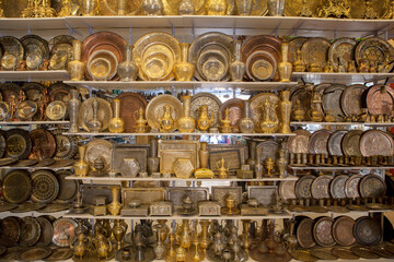 Egyptian traditionally bronze souvenirs on the shelf in the store.