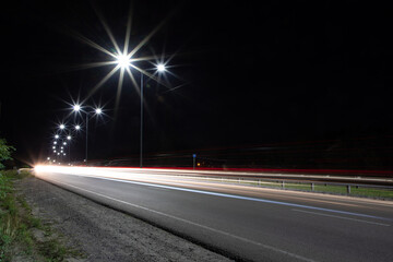 Fototapeta na wymiar Night traffic on the highway with lights