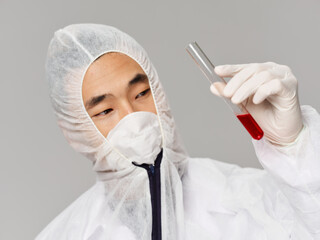 A man of a Georgian protective mask holds blood tests in his hands