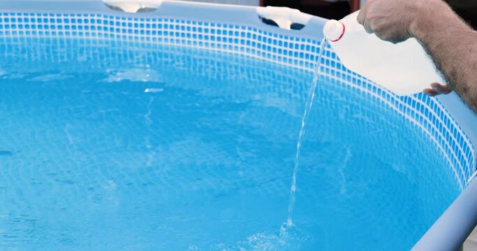 Cleaning a PVC frame pool from algae by pouring perhydrol, Concept of cleaning services.