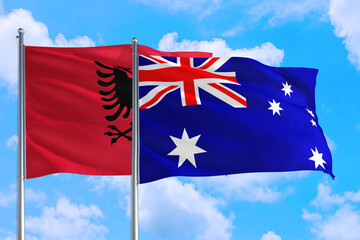 Australia and Albania national flag waving in the windy deep blue sky. Diplomacy and international relations concept.