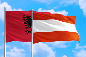 Naklejka na ściany i meble Austria and Albania national flag waving in the windy deep blue sky. Diplomacy and international relations concept.