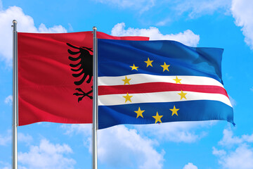 Cape Verde and Albania national flag waving in the windy deep blue sky. Diplomacy and international relations concept.