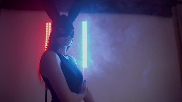 Sexy woman in hare mask posing and gesturing at camera